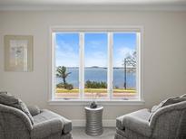 Comfortable sitting area boasts amazing waterfront views through a large window at 2087 Edgewater Dr # C, Clearwater, FL 33755