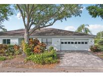 Charming single-story home with a well-manicured lawn and paved driveway at 2529 Lancaster Dr, Sun City Center, FL 33573