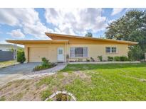 Charming single-story home with a well-maintained lawn and lovely landscaping at 3491 58Th N St, St Petersburg, FL 33710