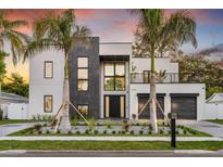 Contemporary two-story home boasting modern design elements, a balcony, and meticulously landscaped front yard at 3604 W El Prado Blvd, Tampa, FL 33629