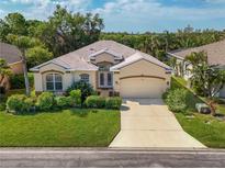 Charming single-story home with a well-manicured lawn, attached two-car garage, and lush landscaping at 4942 Oldham St, Sarasota, FL 34238