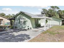 Charming single-story home featuring a covered carport and well-maintained landscaping at 6544 S West Shore Cir, Tampa, FL 33616
