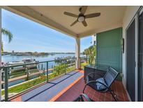 Enjoy breathtaking waterfront views from this condo's spacious balcony with seating and ceiling fan at 1038 Bellasol Way # 202, Apollo Beach, FL 33572