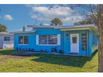 Charming single-story home with a freshly painted blue exterior, green lawn, and well-lit entry at 125 11Th Ave, Indian Rocks Beach, FL 33785