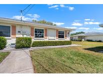 Charming single-story home with manicured lawn and inviting curb appeal at 1901 Canterbury Ln # 14, Sun City Center, FL 33573
