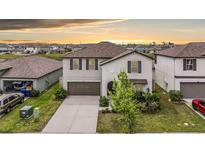 Charming two-story home featuring a well-manicured lawn and attached two-car garage at 8749 Parsons Hill Blvd, Wesley Chapel, FL 33545