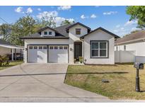Charming two-story home with a manicured lawn, two car garage, and neutral color palette at 1423 W Wood St, Tampa, FL 33604