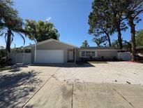 Charming single-story home with a well-maintained yard, driveway, and attached garage in a great neighborhood at 1779 Sunset Point Rd, Clearwater, FL 33755