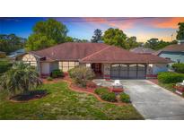 Charming single-story home with stone accents and well-manicured landscaping at 2017 Godfrey Ave, Spring Hill, FL 34609