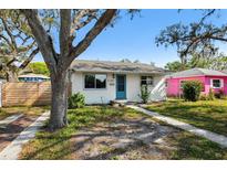 Charming single story home with blue door, white paint and well manicured yard at 4701 14Th S Ave, St Petersburg, FL 33711