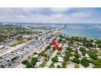 Aerial view of condo community showcasing waterfront location with beautiful bridge and surrounding neighborhood at 147 Bluff View Dr # 206, Belleair Bluffs, FL 33770