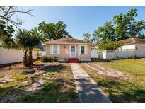 Charming single-story home featuring a welcoming walkway, fresh exterior paint, and a neatly fenced yard at 217 50Th N Ter, St Petersburg, FL 33703