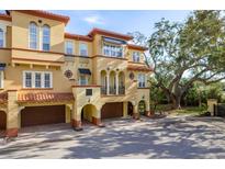 Mediterranean-style home featuring arched entryways and beautiful architecture with an attached garage at 264 Seagate Ct, Dunedin, FL 34698