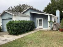 Charming single-Gathering home featuring a well-maintained front yard and covered entry at 4315 Longshore Dr, Land O Lakes, FL 34639