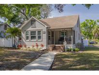 Charming bungalow with inviting front porch, mature landscaping, and a welcoming walkway at 505 27Th N Ave, St Petersburg, FL 33704
