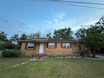 Cozy single story home with a simple porch and tidy front yard at 703 E Hamilton Ave, Tampa, FL 33604