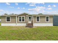Charming single-story home with neutral siding, white trim, and a well-maintained front lawn at 11309 Tulane St, New Port Richey, FL 34654