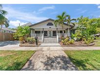 Charming home with a white picket fence, well-manicured lawn, and inviting front porch at 1330 Cherry Ne St, St Petersburg, FL 33701