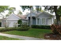 Charming single-story home with well-manicured lawn and lush landscaping, creating great curb appeal at 1803 Longview Ln, Tarpon Springs, FL 34689