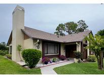 Inviting single-story home with well-maintained landscaping, complemented by colorful flowers at 2250 Sequoia Dr, Clearwater, FL 33763