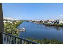Beautiful waterfront view featuring a serene channel, docks, and coastal residences under a clear blue sky at 459 Bahia Beach Blvd, Ruskin, FL 33570