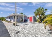 Charming home with a carport and shed featuring durable and stylish brick paver driveway at 4851 W Gandy Blvd # B3 L8, Tampa, FL 33611