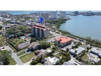 An aerial view shows the building is next to a pool and a tennis court at 7037 Sunset S Dr # 205, South Pasadena, FL 33707