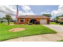 Charming single-story home with well-manicured lawn and attached garage at 10601 42Nd N Ct, Clearwater, FL 33762