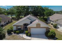 Charming home featuring manicured landscaping, attached two-car garage, and a well-maintained lawn at 322 Northway Dr, Sun City Center, FL 33573