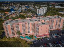 Aerial view of condo showcasing its pool, balconies, and proximity to waterfront living at 4516 Seagull Dr # 615, New Port Richey, FL 34652