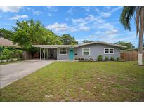Charming single-story home with a well-maintained lawn, carport, and an inviting, brightly colored front door at 5115 32Nd N Ave, St Petersburg, FL 33710