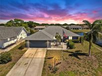 Charming single-story home with a well-manicured lawn, an American flag, and a spacious two-car garage at 613 Fort Duquesna Dr, Sun City Center, FL 33573
