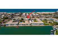 An aerial view of the condos, pier, and beach with water views in a lovely area at 6161 Gulf Winds Dr # 338, St Pete Beach, FL 33706