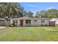 Charming single-story home featuring a well-maintained lawn and inviting front entrance at 6936 77Th N Ter, Pinellas Park, FL 33781