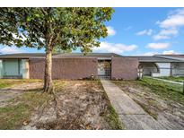 Charming home featuring a secure gated front entrance and walkway to the front door at 8325 Elkwood Ln, Tampa, FL 33615