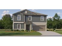 Charming two-story home features a two-car garage, landscaped front yard and stylish facade at 35105 Brackett Bnd, Zephyrhills, FL 33541