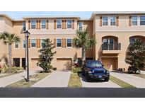 Inviting exterior of a townhome with a blue Jeep parked in front of the garage at 5524 Yellowfin Ct, New Port Richey, FL 34652