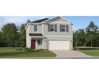 Charming two-story home with a landscaped yard and a two-car garage at 5631 Red Kite Dr, Wimauma, FL 33598