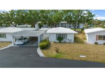 Charming single-story home with a carport, well-maintained lawn and tiled roof at 1805 Vera Pl # 2, Sarasota, FL 34235