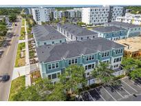 Aerial view of townhomes with gray roofs and parking in a walkable community near retail and restaurants at 3113 4Th N Ter, St Petersburg, FL 33713