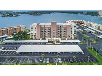 An aerial view of the property with assigned covered parking and a beautiful waterfront view at 7700 Sun Island S Dr # 404, South Pasadena, FL 33707