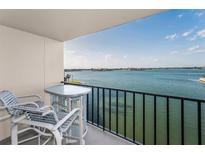 Relax on this condo balcony with outdoor furniture and take in the beautiful view of the water at 7700 Sun Island S Dr # 404, South Pasadena, FL 33707