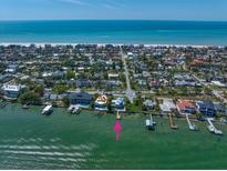 Breathtaking aerial view of waterfront home with private dock and Gulf of Mexico backdrop at 785 Bay Esplanade, Clearwater Beach, FL 33767