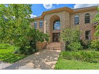 Stately brick home with a grand arched entryway and well-manicured landscaping at 1203 Parrilla De Avila, Tampa, FL 33613