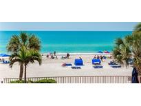 Beautiful beach view with white sand, palm trees, and blue water at 18400 Gulf Blvd # 1211, Indian Shores, FL 33785