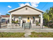 Charming single-story home with a cozy front porch and decorative wrought iron fence at 2818 N 19Th St, Tampa, FL 33605