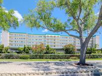 Spacious condominium complex with meticulous landscaping, blue trim accents, and a picturesque facade at 2960 59Th S St # 102, Gulfport, FL 33707