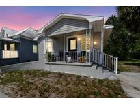 Quaint bungalow-style home with a welcoming front porch and well-maintained landscaping at 412 E Columbus Dr, Tampa, FL 33602