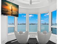 Bright sitting area with waterfront views and modern decor, perfect for relaxing and enjoying the scenery at 6130 Kipps Colony W Dr, Gulfport, FL 33707