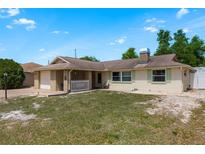Charming single-story home featuring a brick facade and an attached garage, inviting curb appeal at 6831 Greenwich Ave, New Port Richey, FL 34653